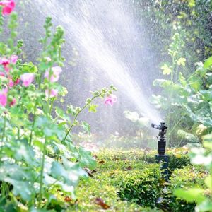 Photo of water sprinkler in a flower bed.